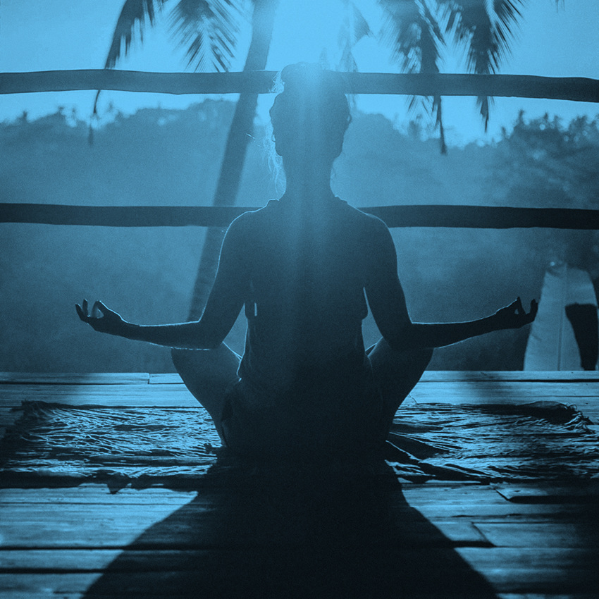  person sitting on the ground meditating